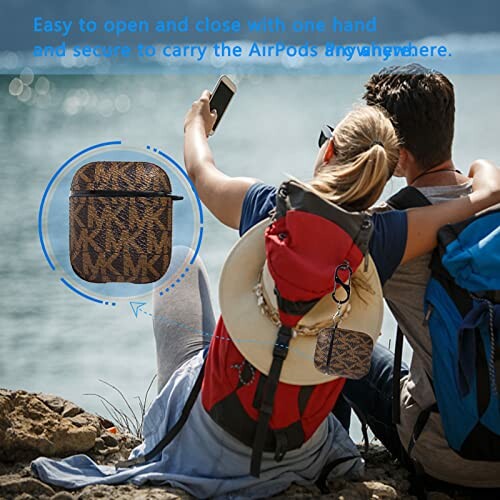 Couple sitting on rocks, using phone with AirPods case attached to backpack.