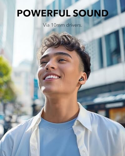 Man enjoying music with earbuds on city street