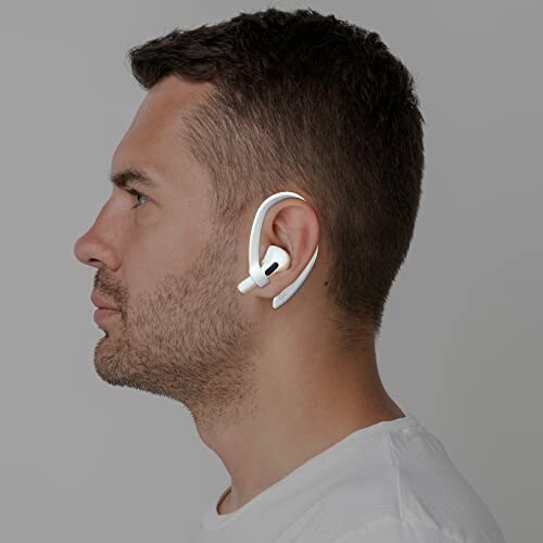 Man wearing white wireless earbuds