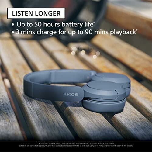 Sony headphones on a bench with text about battery life and quick charge.