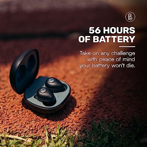 Wireless earbuds with 56 hours of battery life displayed on a textured surface.