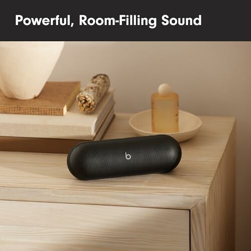 Wireless speaker on wooden table with decor