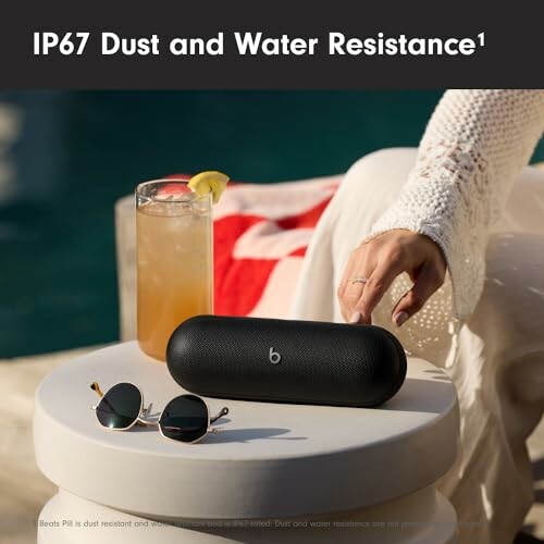 Wireless speaker with IP67 dust and water resistance by a poolside.