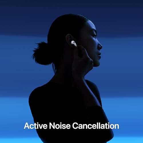 Silhouette of woman using noise-cancelling earbuds.