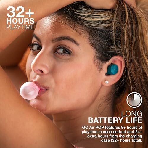 Woman with earbuds blowing bubble gum, highlighting long battery life.