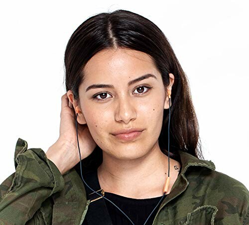 Woman with long hair wearing earphones and a camouflage jacket.